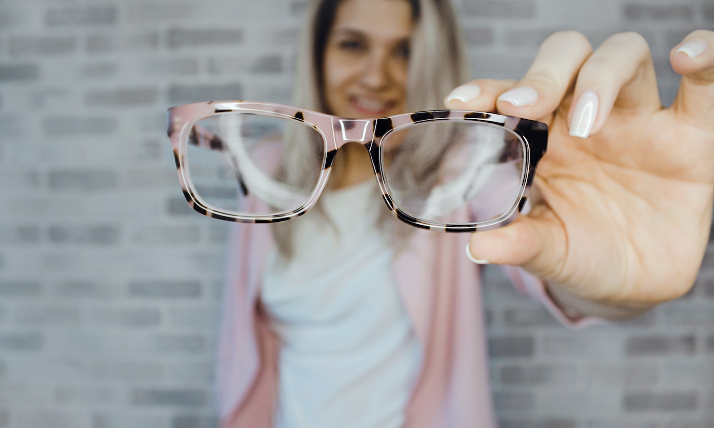 woman taking off spectacles for her photo