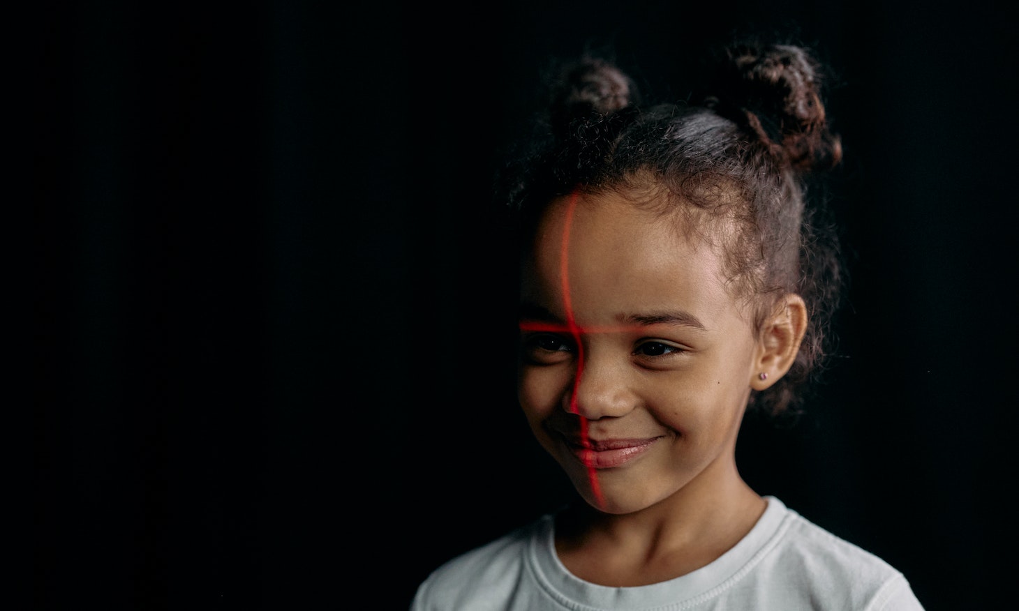 a smiling girl having her face scanned