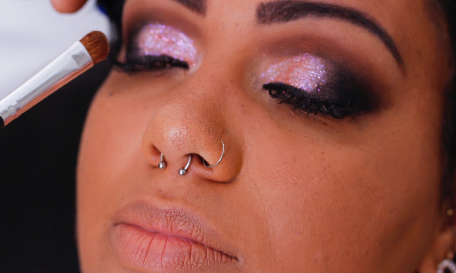 woman with bright glitter on each eye lid