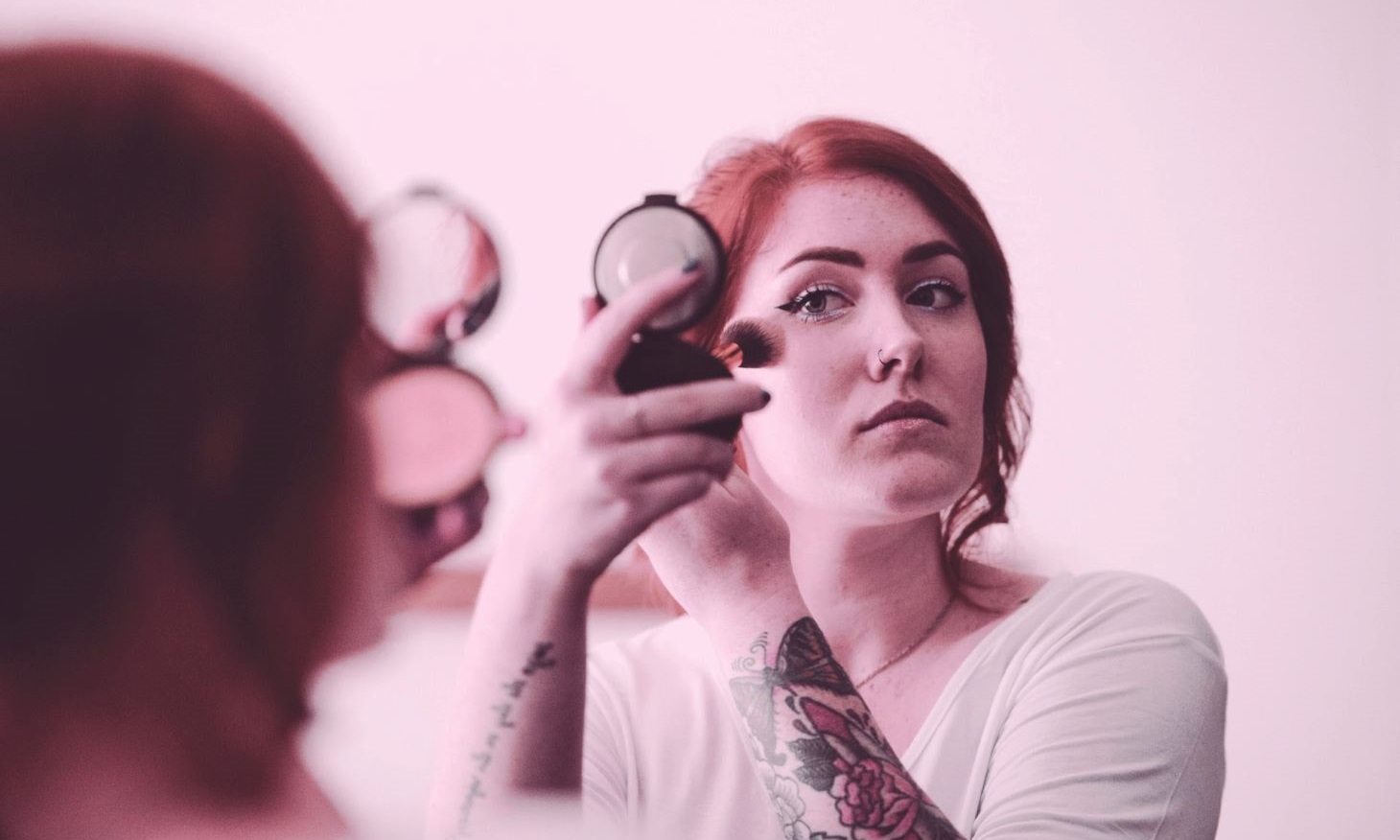 woman applying make-up to look fresh on camera