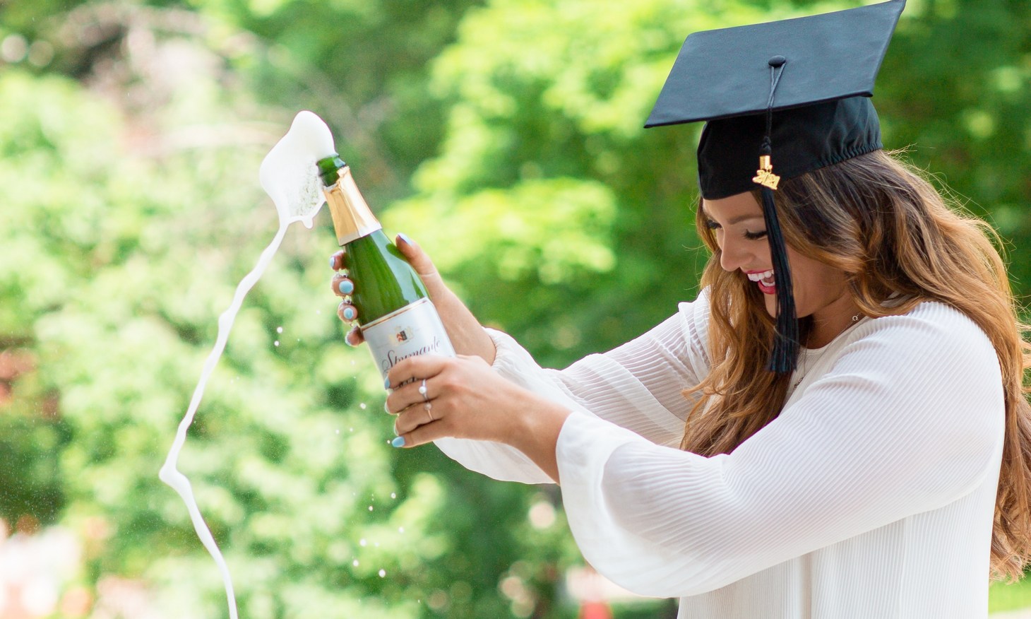 grad photo with champagne